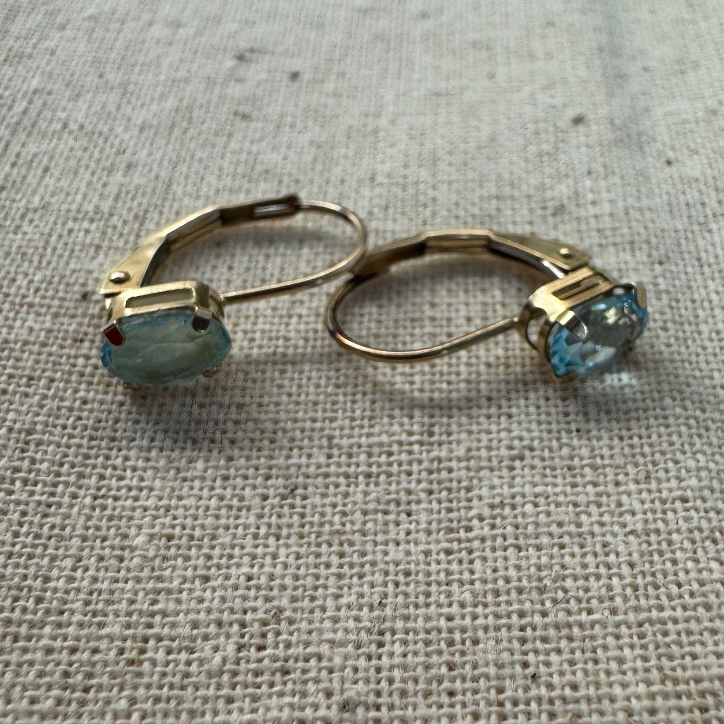10K gold drop earrings set with sparkling blue topaz