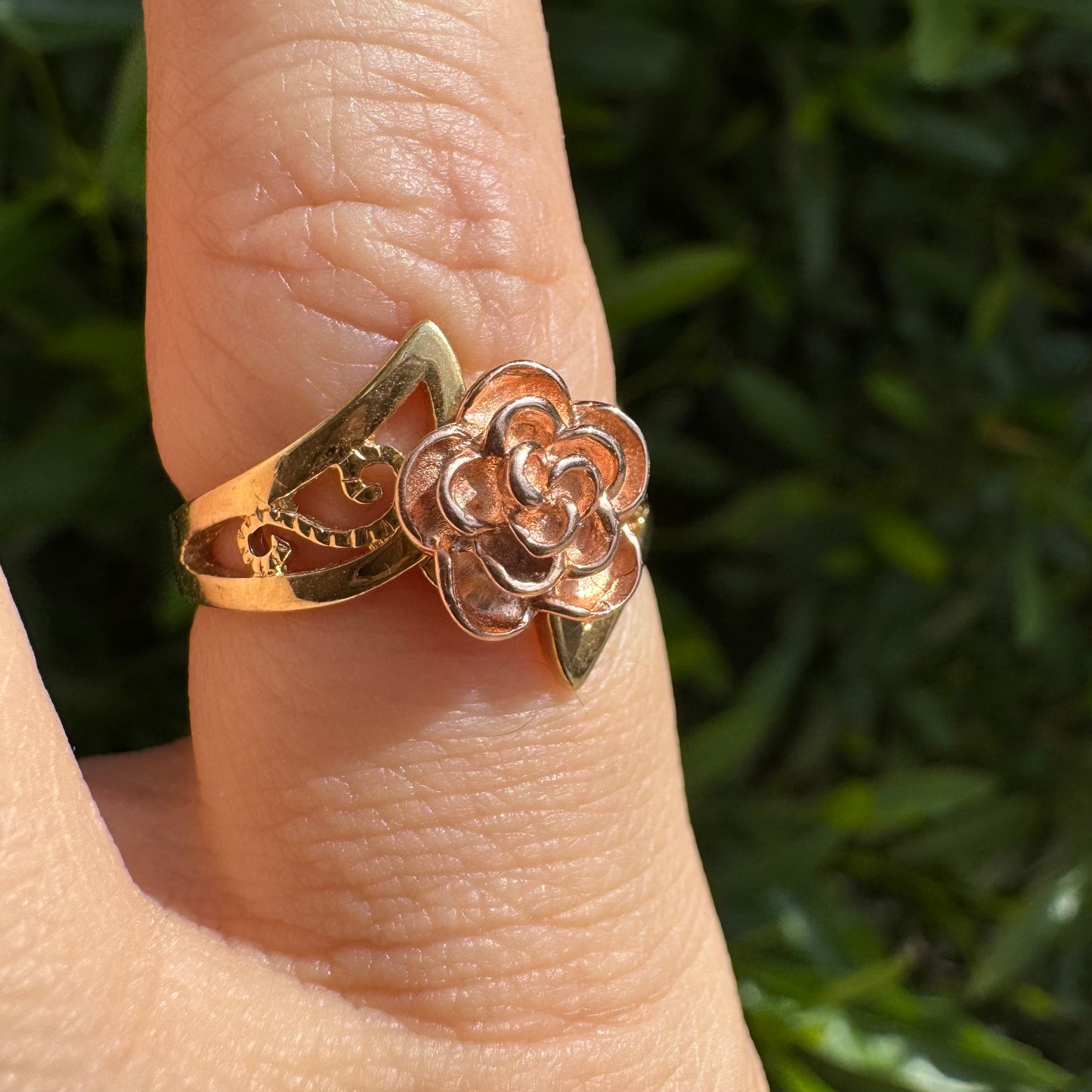 10K two tone gold with a sculpted rose at its center