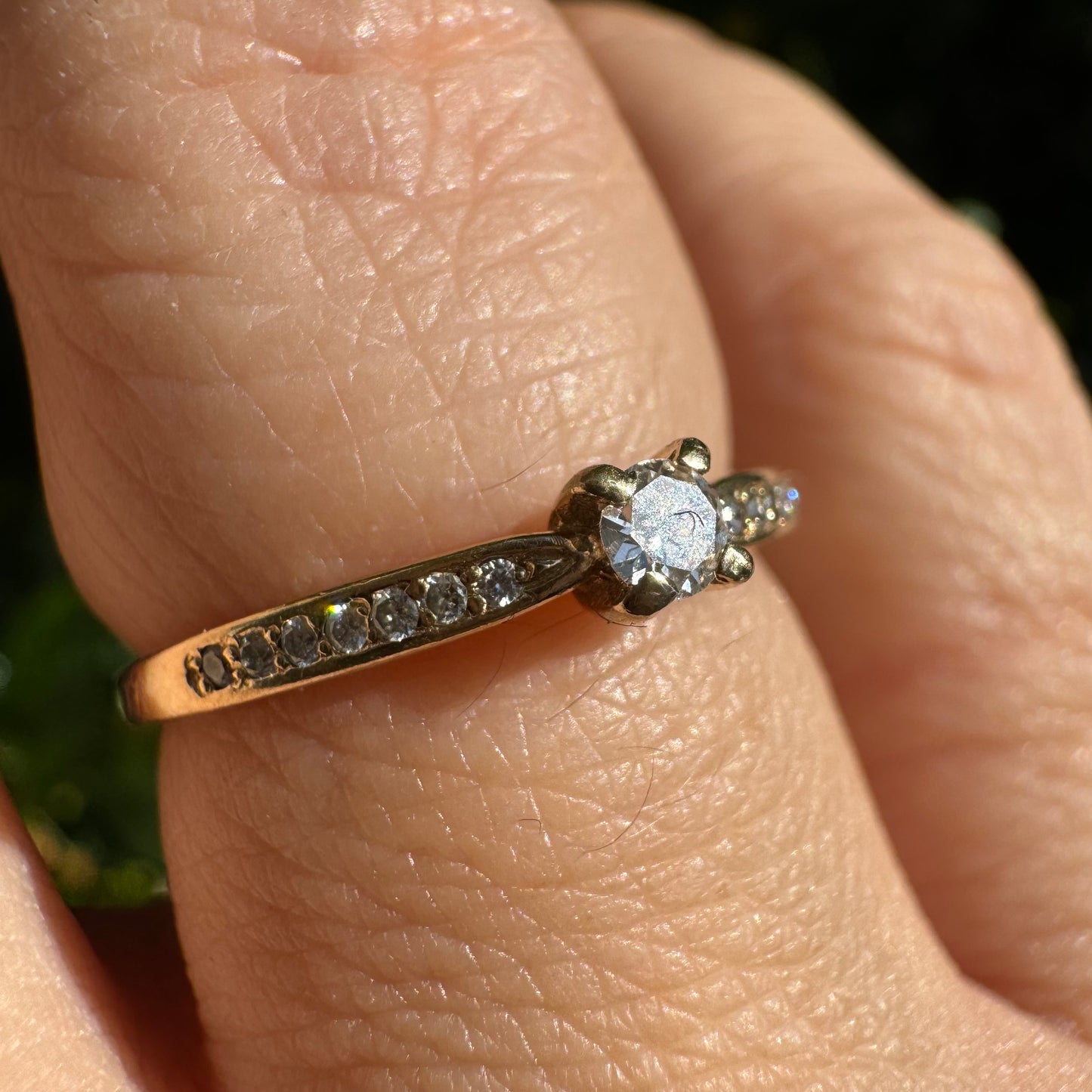 14K gold ring set with one center Diamond and side Diamonds