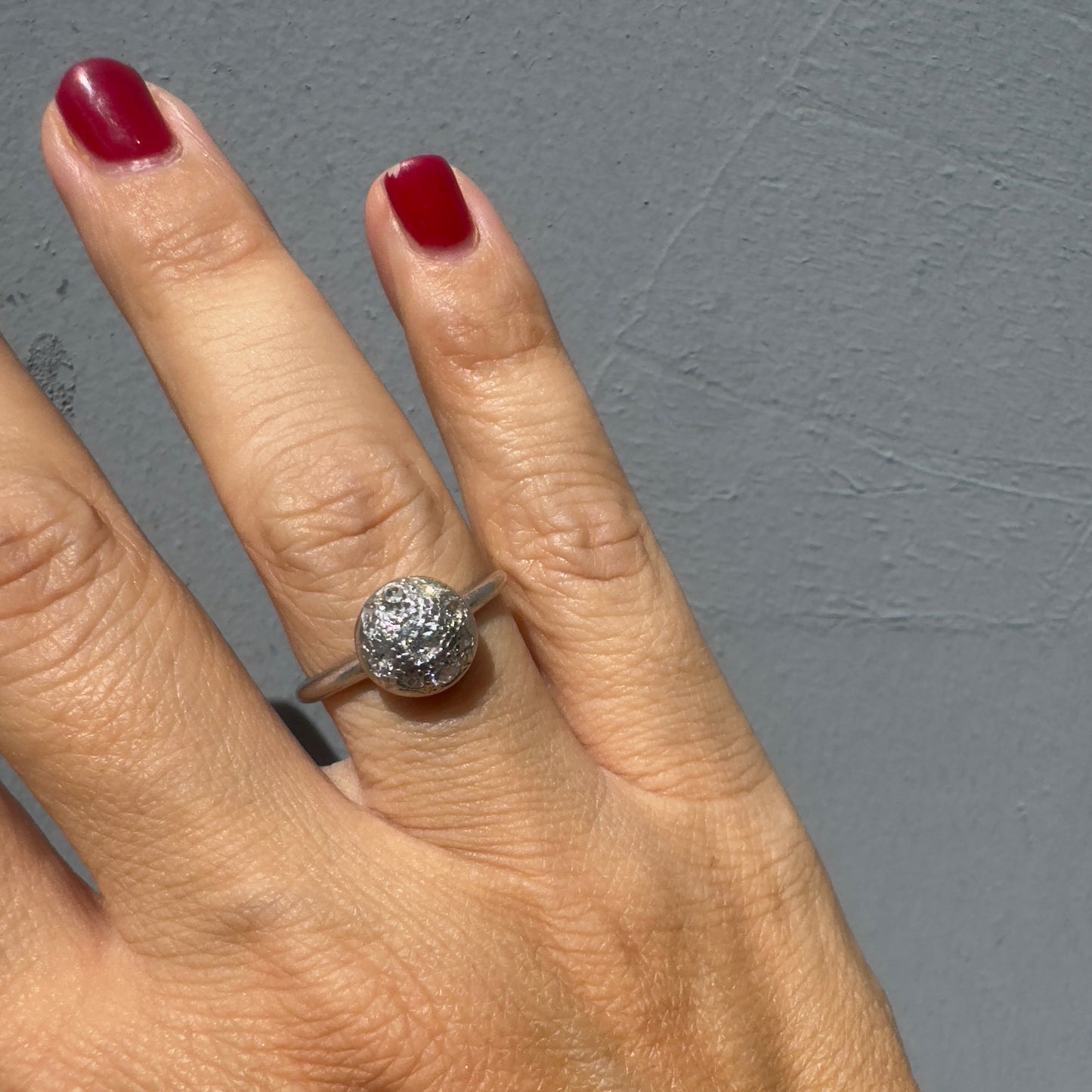 A platinum ring featuring a round cluster of sparkling Diamonds set at the center, creating a bold and elegant look.