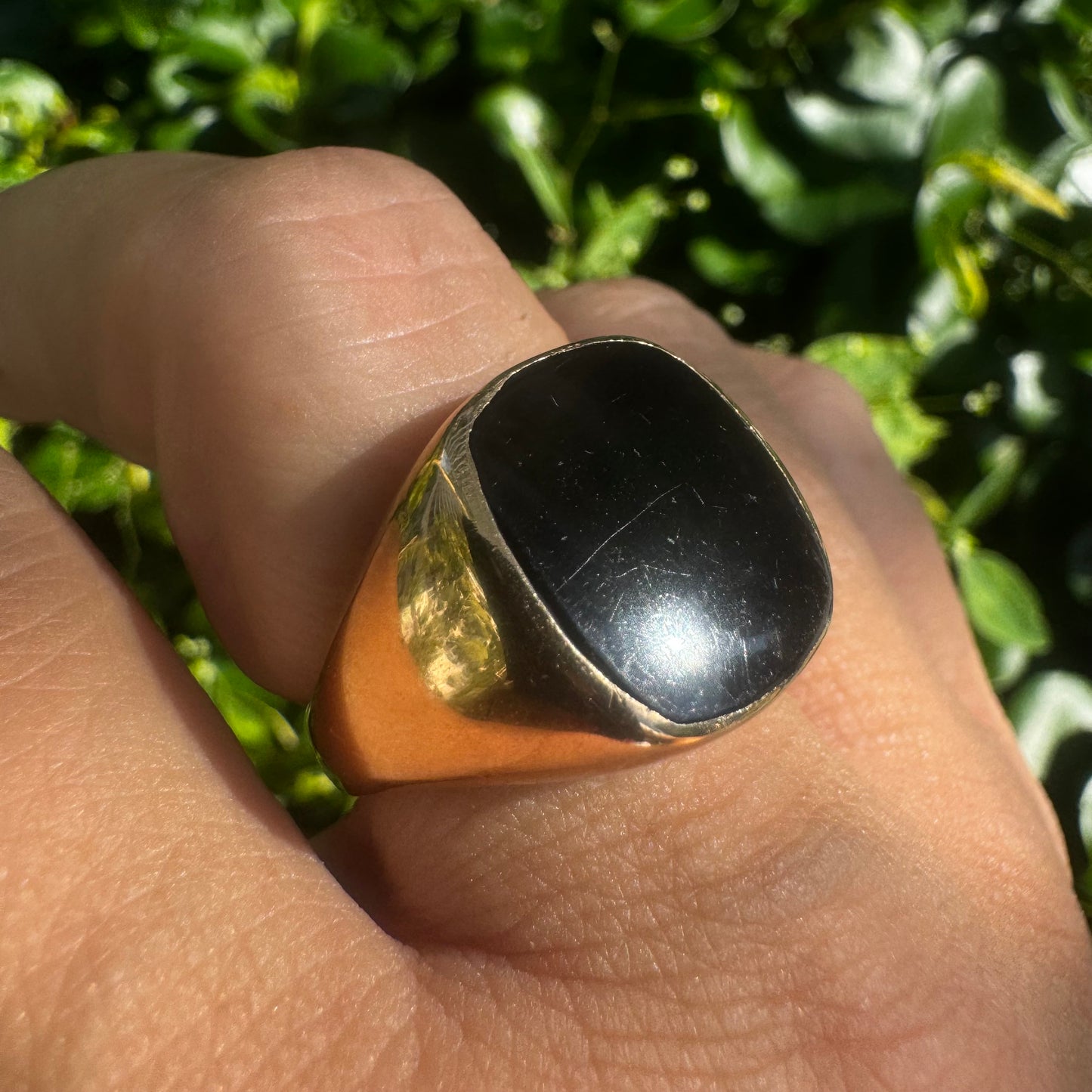 14K bold gold ring set with a smooth, square-shaped black Onyx that creates a sleek and striking look.