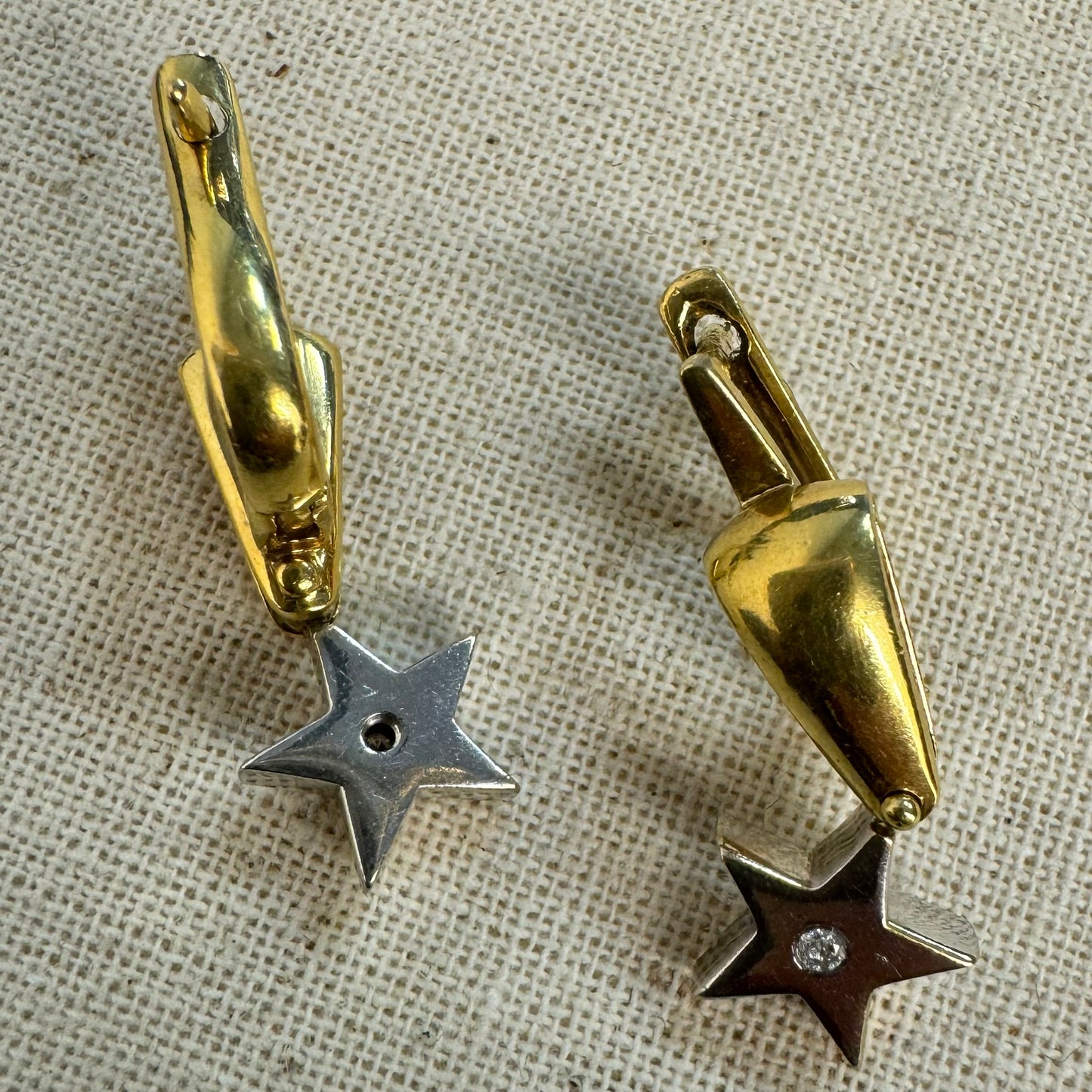 18K gold earrings set with a sparkling Diamond at the center.