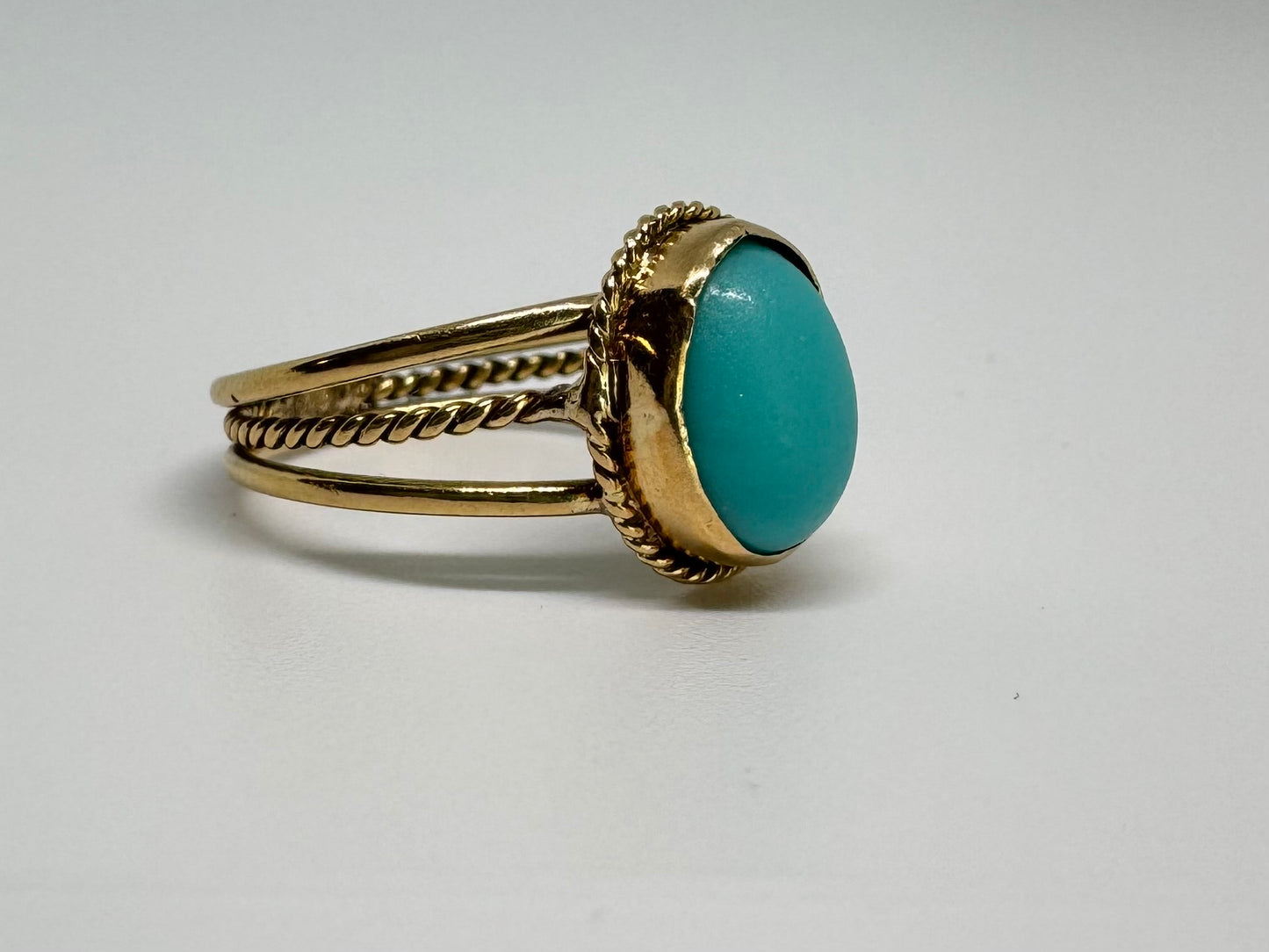 14K gold ring set with an oval Turquoise stone in a delicate rope-style bezel