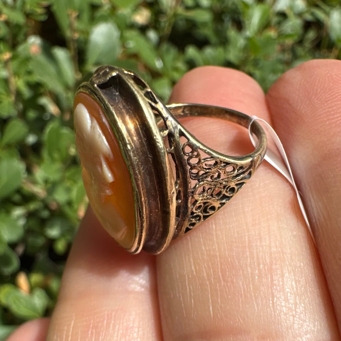 14K gold cameo ring featuring a finely carved portrait of a woman in profile, set in an oval bezel with intricate gold detailing