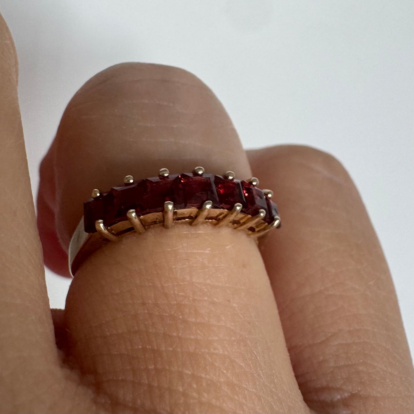 9K gold ring set with deep red garnets