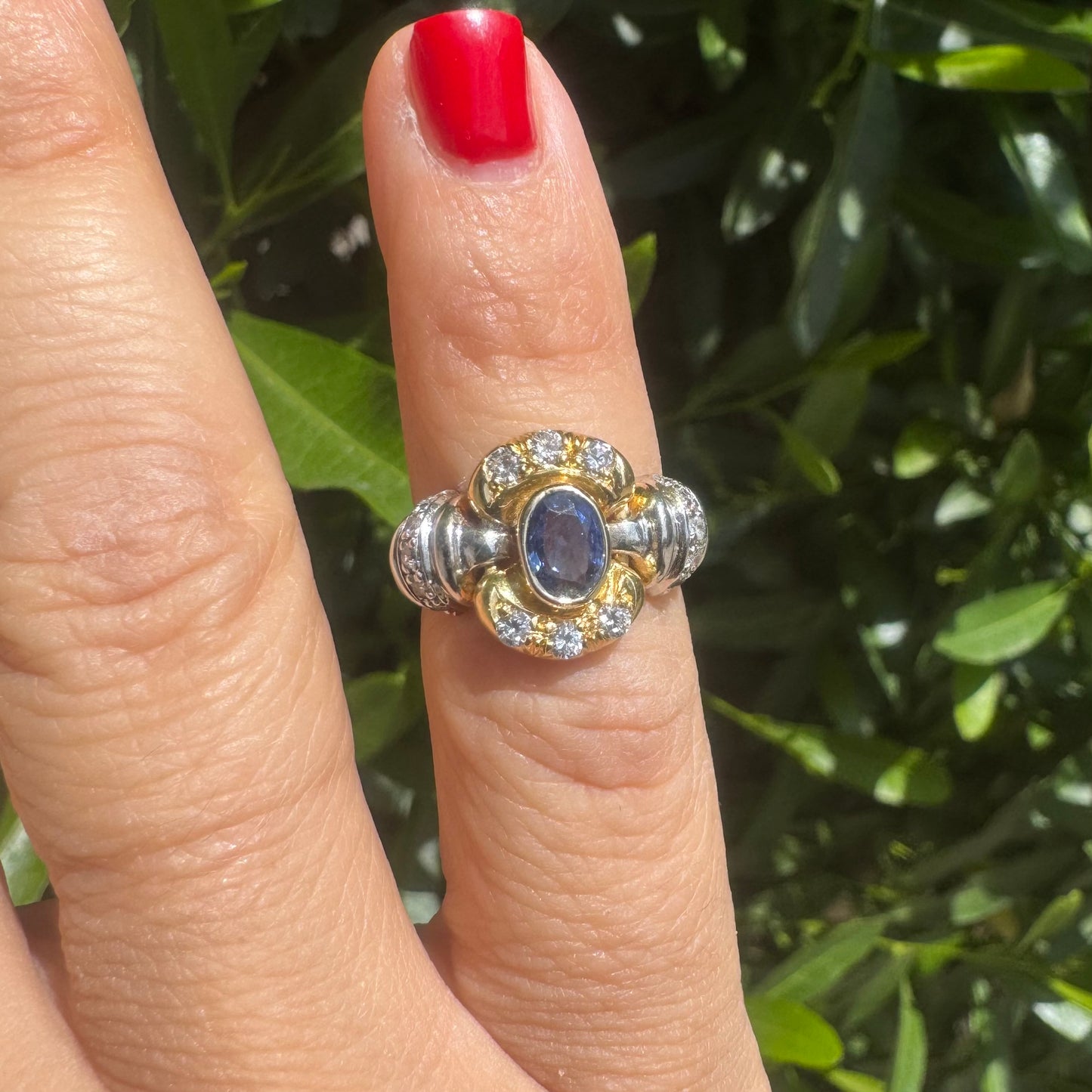 18K two-tone gold ring set with an oval Tanzanite & round brilliant diamonds