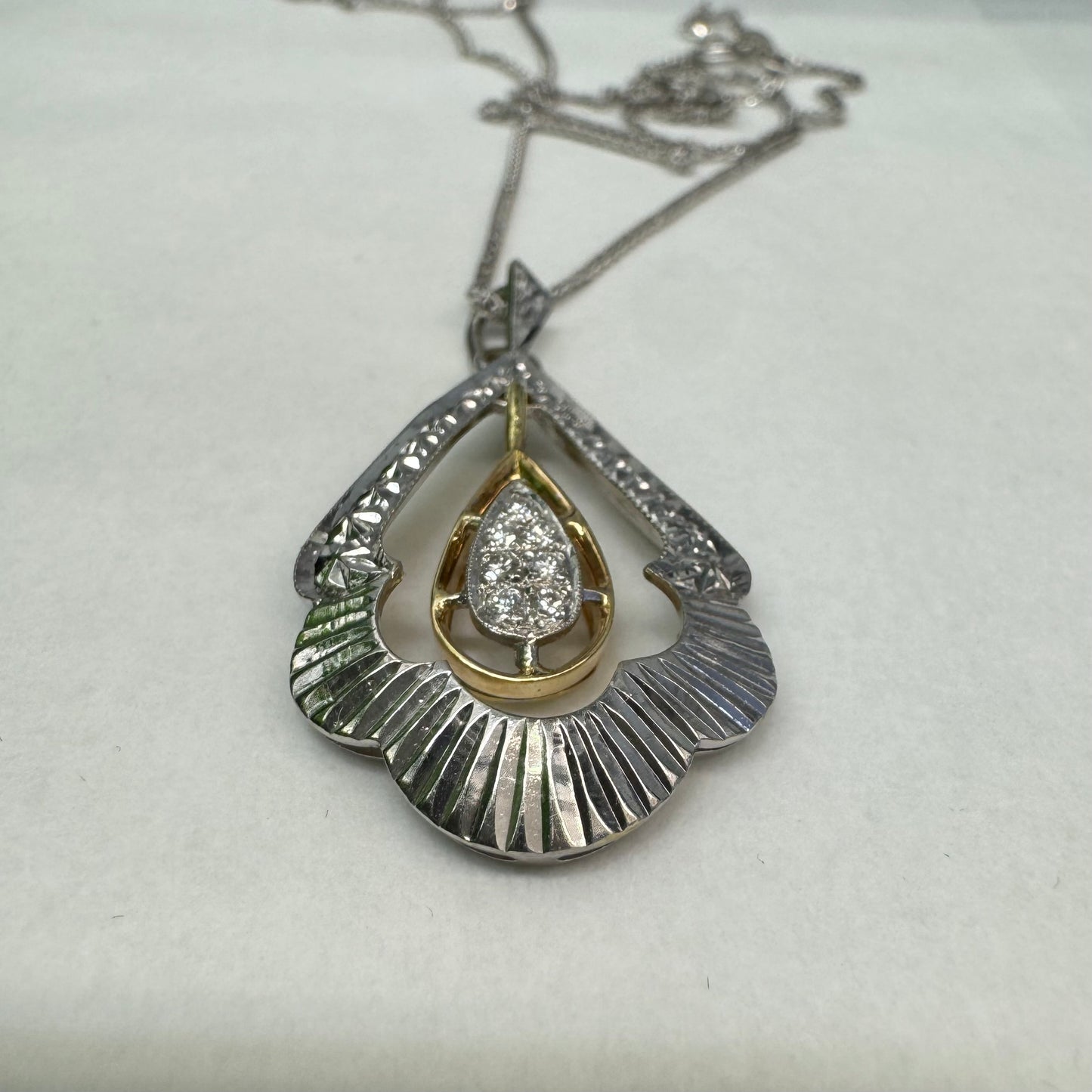 14K white and yellow gold pendant in a unique geometric design set with Diamonds