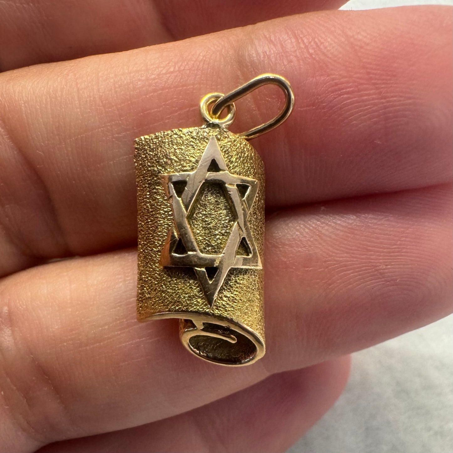 18K gold handcrafted pendant in the shape of a scroll, featuring a raised Star of David.