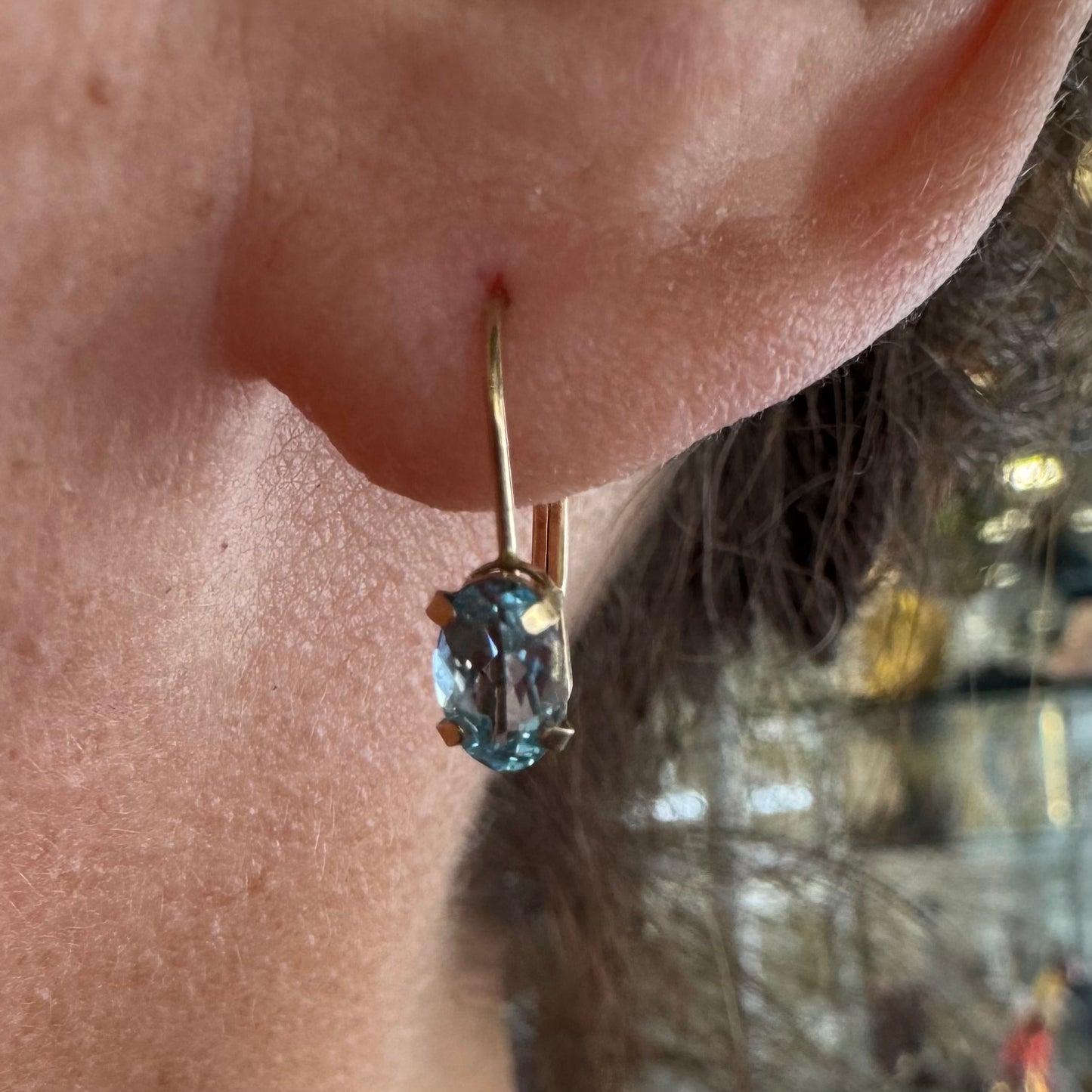 10K gold drop earrings set with sparkling blue topaz