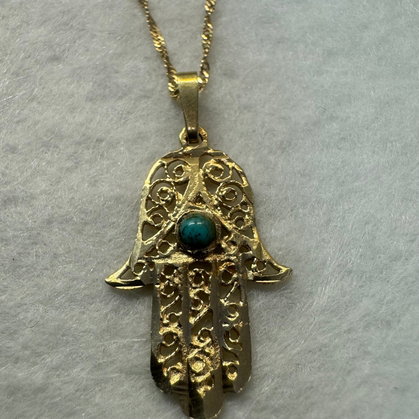 14K gold necklace with “Hamsa” pendant set with a center Turquoise stone