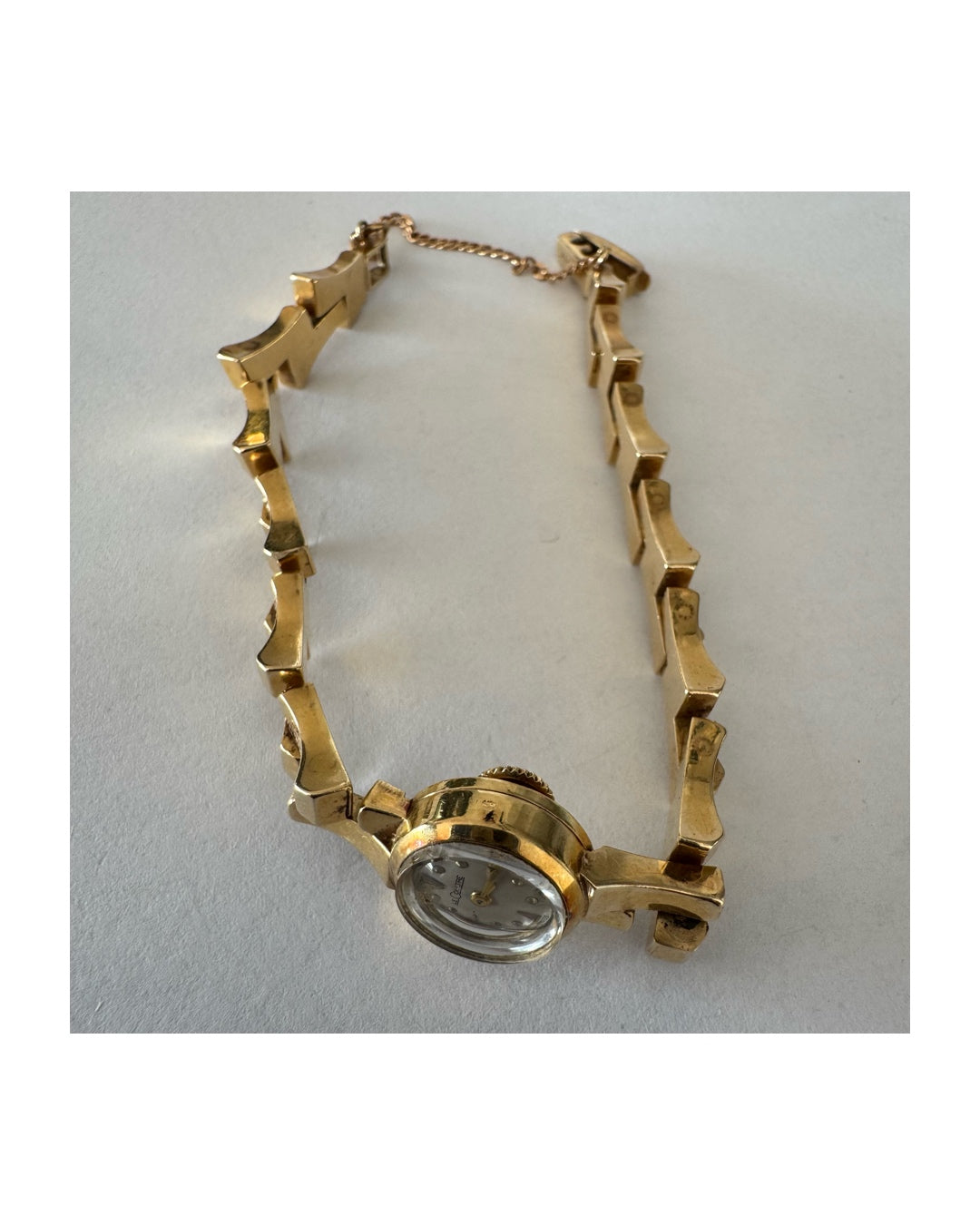 שעון נשים של Jaeger-LeCoultre מזהב 18 קראט, בעל צמיד אינטגרלי בעיצוב פיסולי ולוח מחוגים מינימליסטי ואלגנטי.