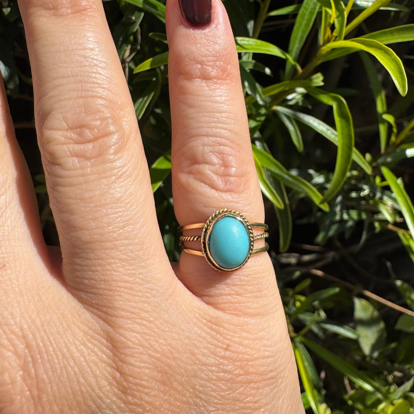 14K gold ring set with an oval Turquoise stone in a delicate rope-style bezel