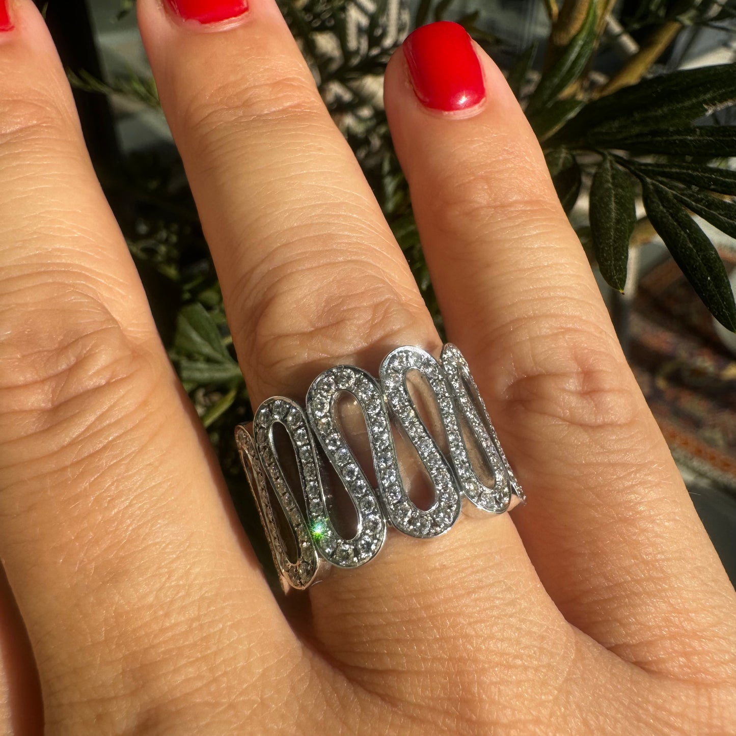 14K gold ring set with shimmering Diamonds in a flowing wave design