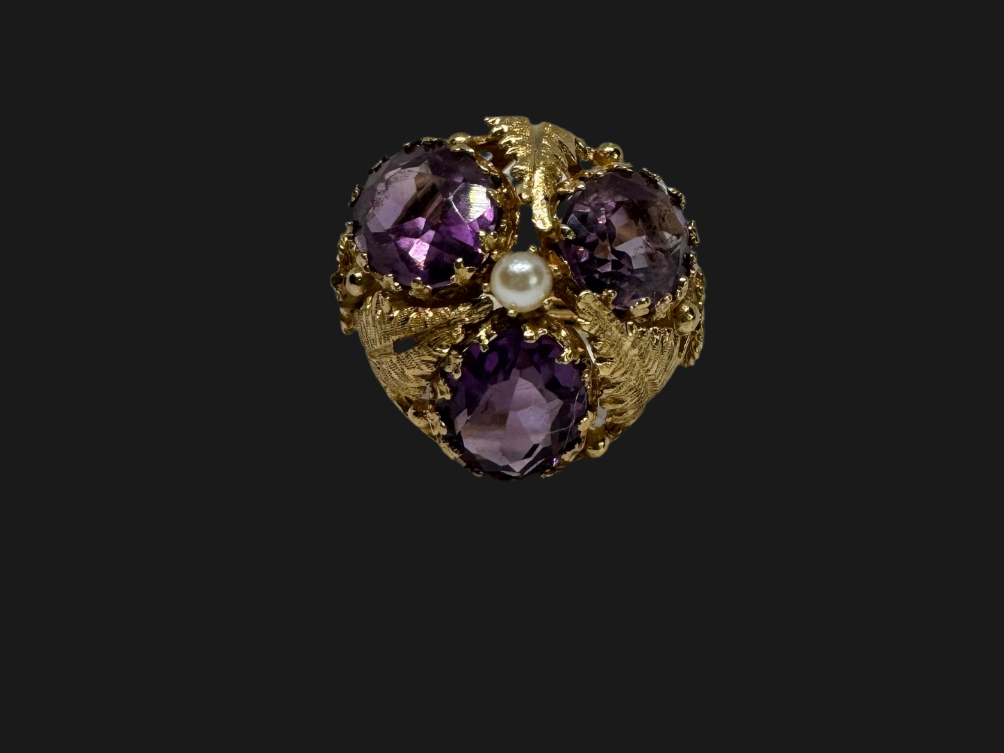 14K gold ring set with four glowing Amethyst stones encircling a delicate central Pearl.