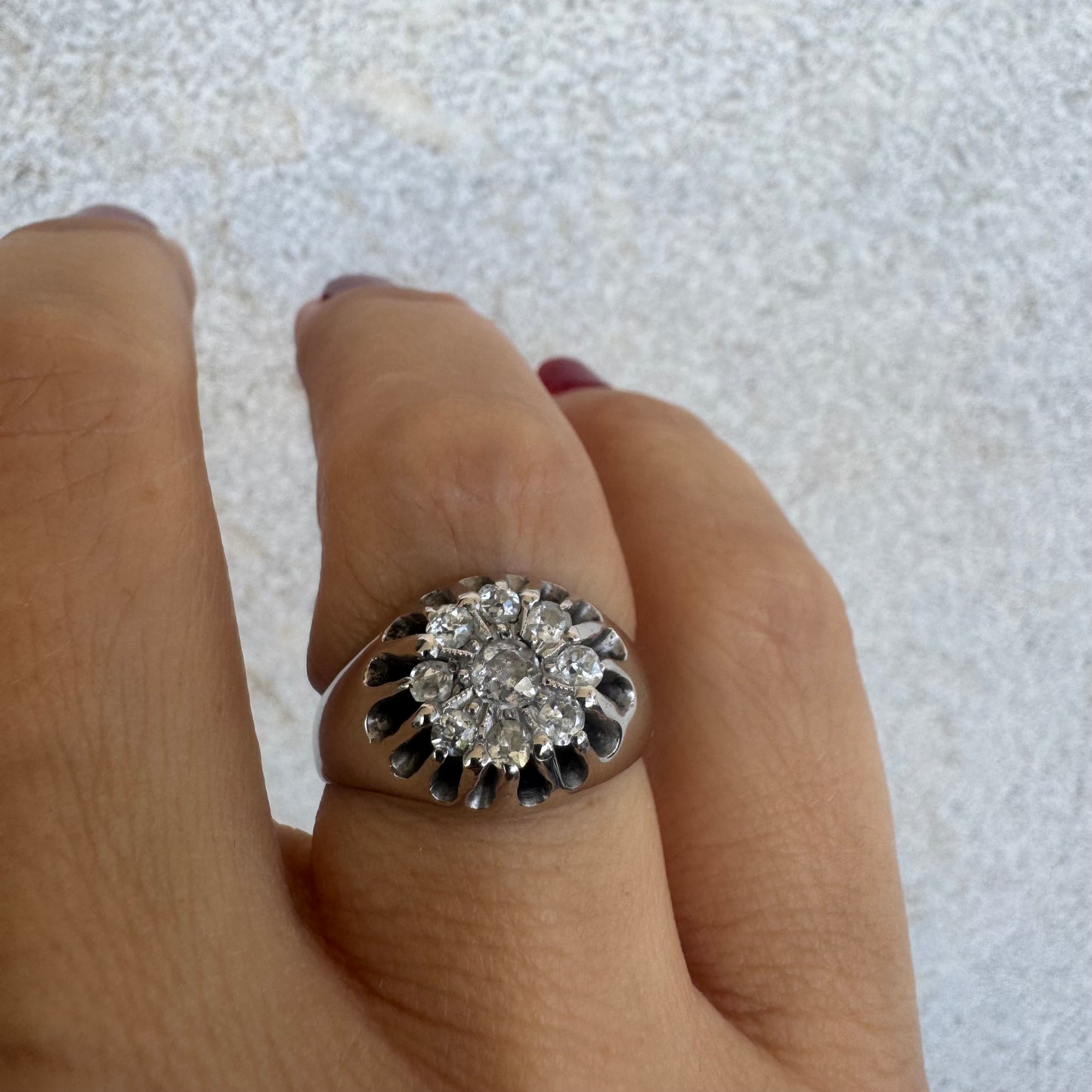 14K gold ring set with a cluster of old cut diamonds arranged in a floral design