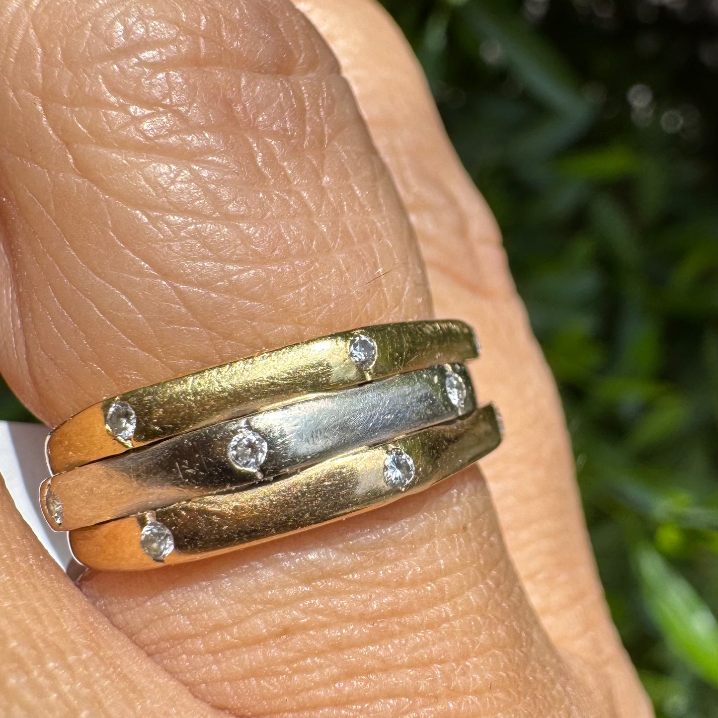 18K gold ring crafted in yellow, white, and rose gold, featuring a triple-band design set with Diamonds