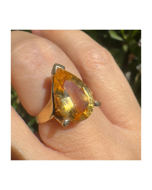 טבעת זהב צהוב 14 קראט משובצת באבן סיטרין גדולה בחיתוך טיפה, עם זהב שמחבק אותה בצורה פתוחה ומודרנית.