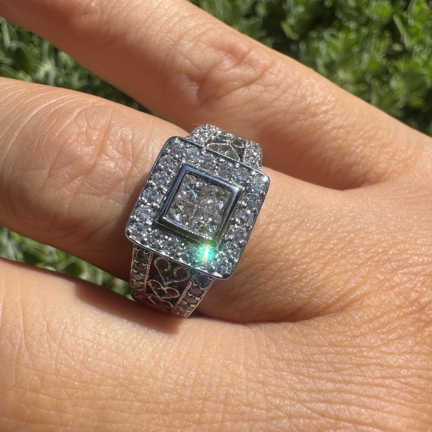 14K gold ring featuring a square cluster of princess-cut Diamonds in the center, surrounded by a double halo of smaller round Diamonds & gold details along the band.