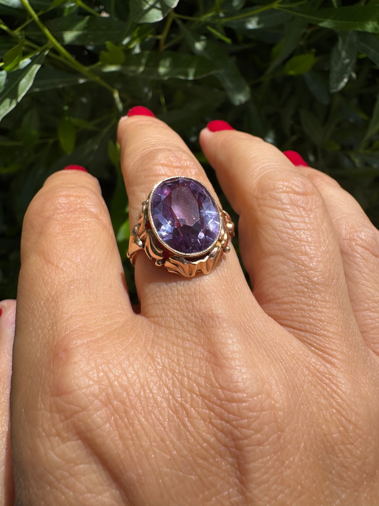 14K gold ring set with a large oval-cut Amethyst in a regal claw setting.