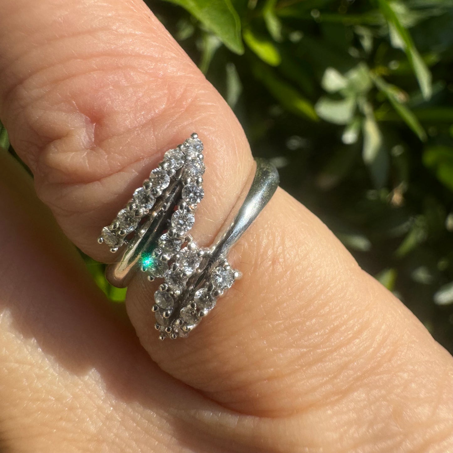 14K gold ring with an open design, featuring two curved rows of sparkling Diamonds that cross over each other elegantly.