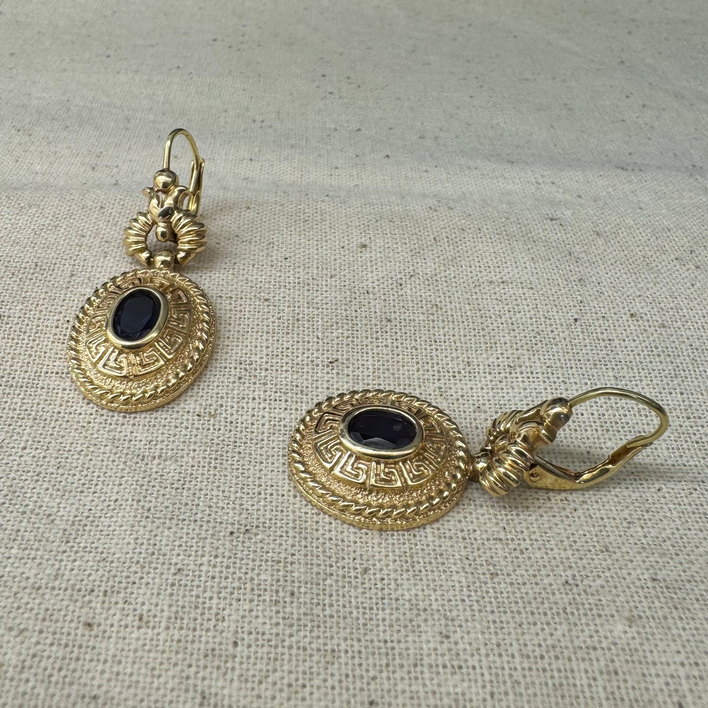 14K gold drop earrings set with Tanzanite in ornate medallion