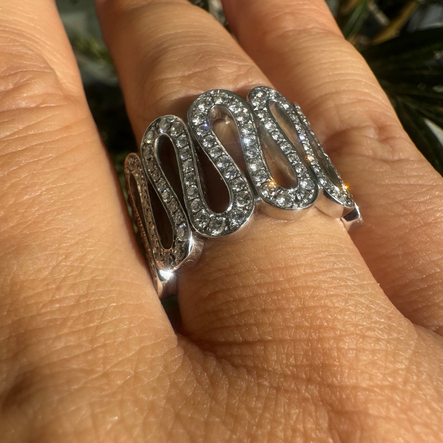 14K gold ring set with shimmering Diamonds in a flowing wave design