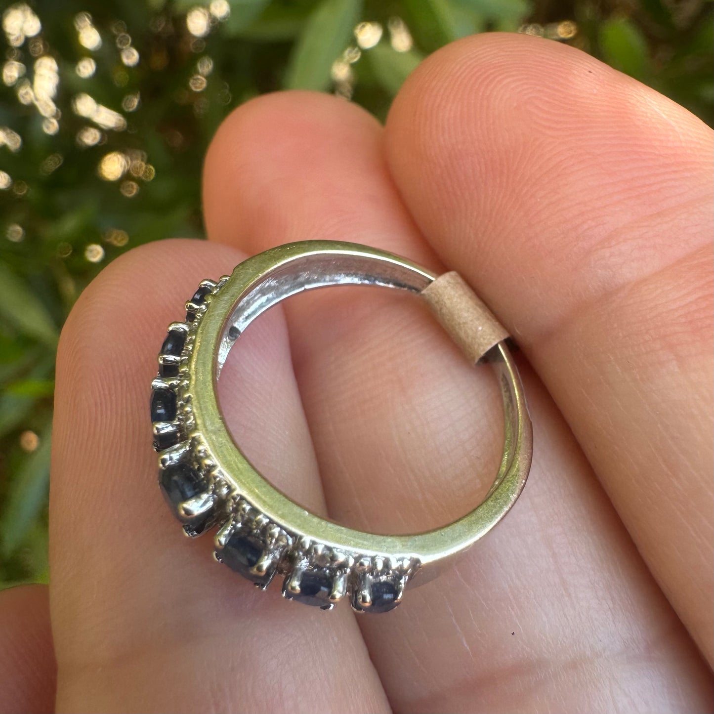 18K gold ring set with deep blue sapphires in a classic round cut, framed by two shimmering rows of brilliant Diamonds.