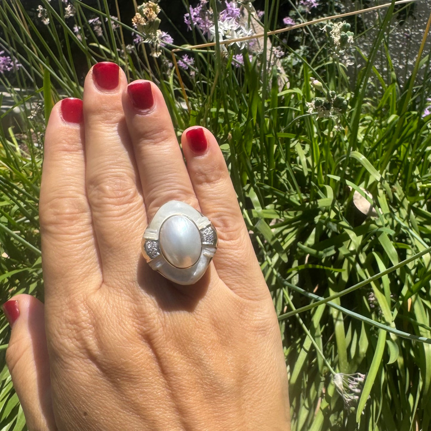 14K gold ring set with a natural mother-of-pearl centerpiece framed by delicate diamond accents