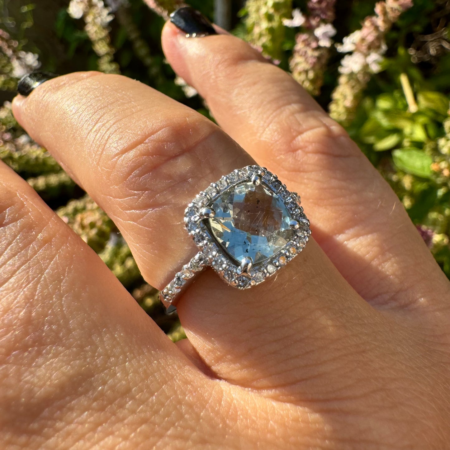 14K white gold ring featuring a cushion-cut light blue Aquamarine set in a sparkling double halo of round-cut Diamonds.
