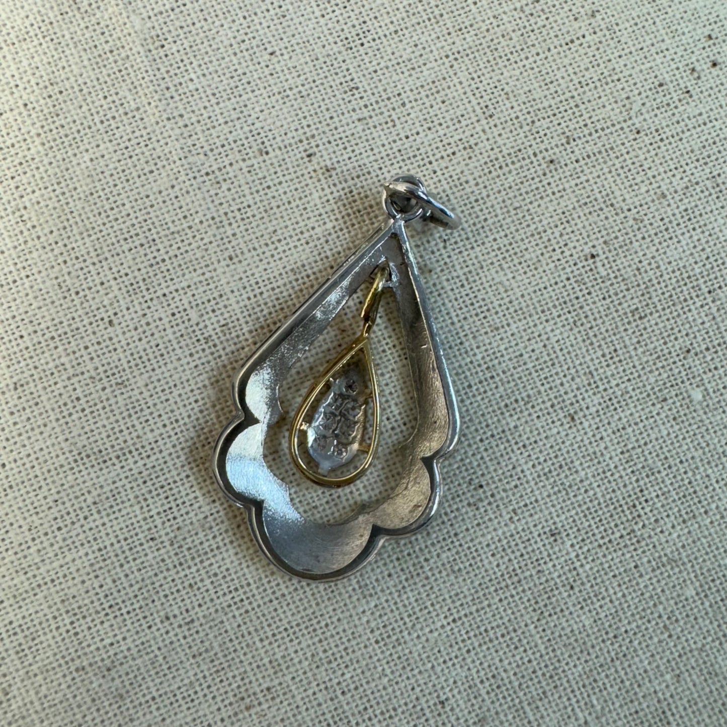 14K white and yellow gold pendant in a unique geometric design set with Diamonds