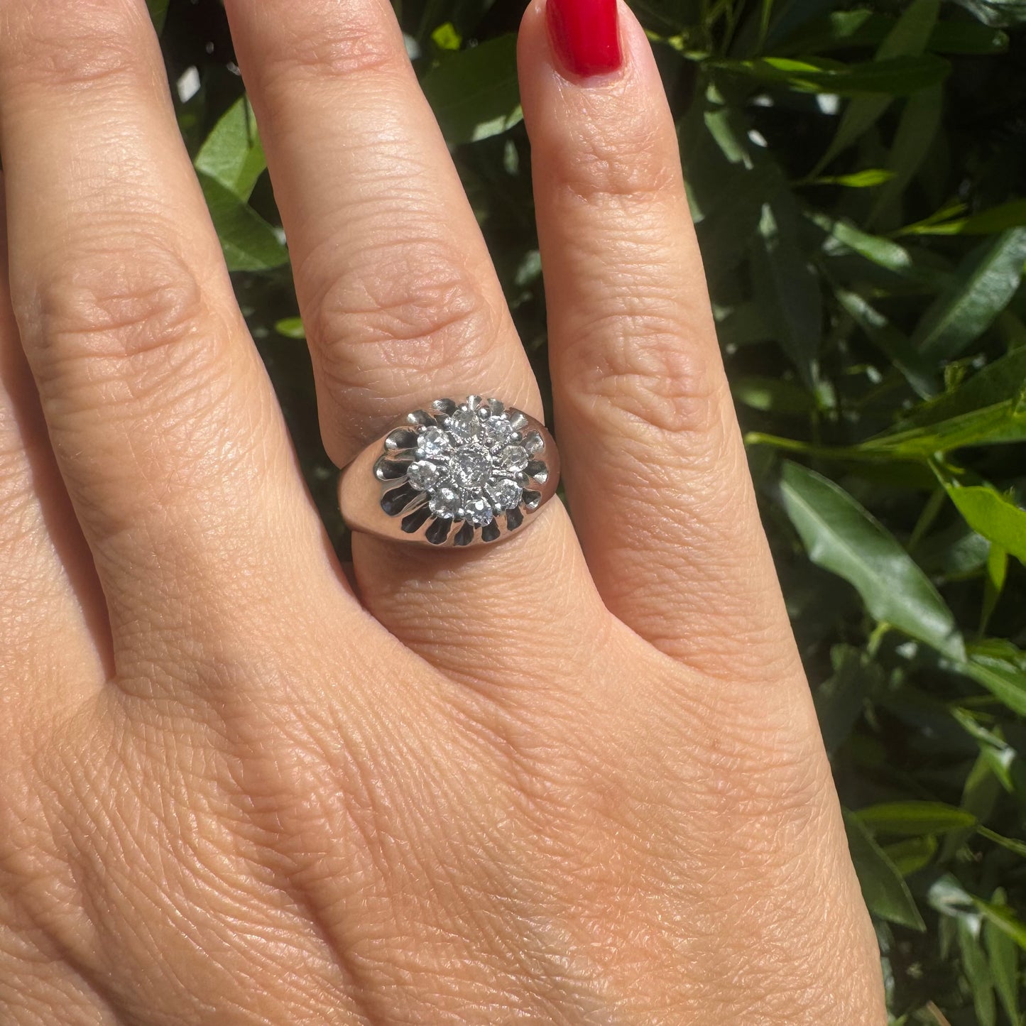 14K gold ring set with a cluster of old cut diamonds arranged in a floral design