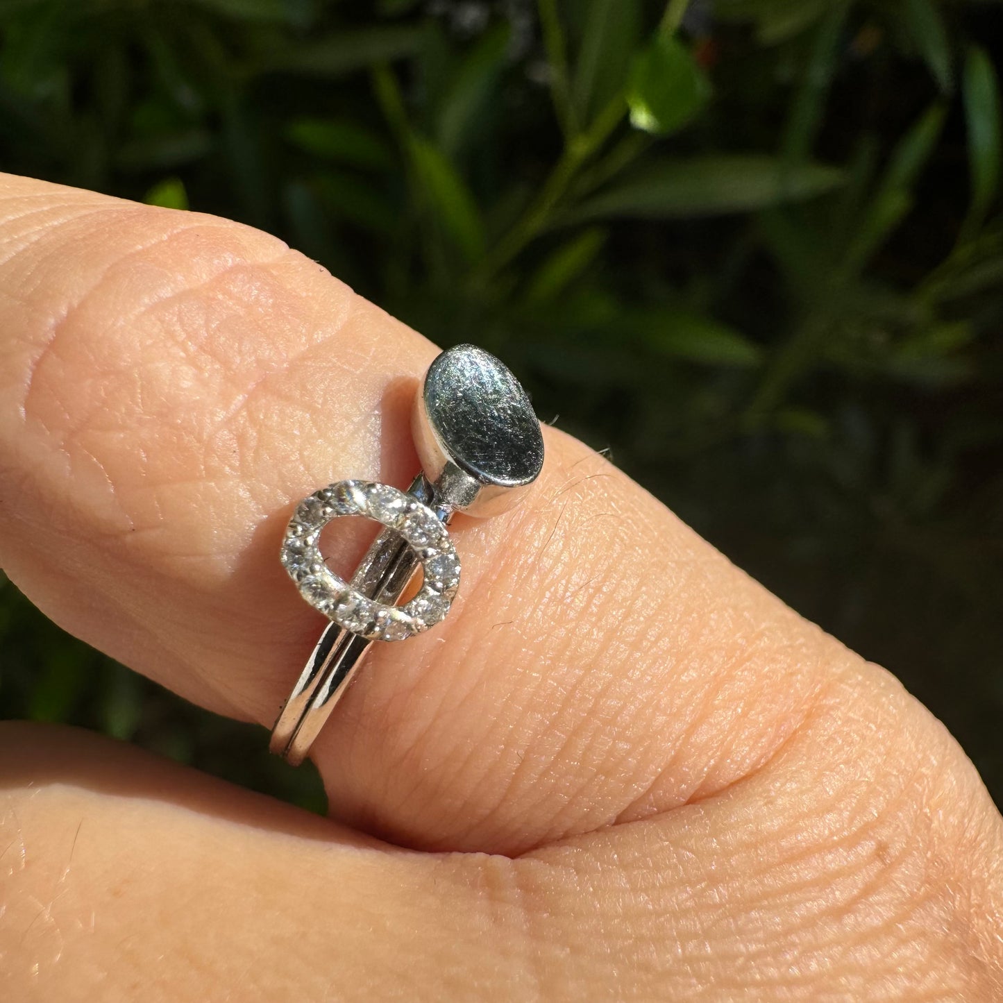 14K gold open ring featuring two ends: one with a sparkling oval of Diamonds and the other with a smooth polished oval.