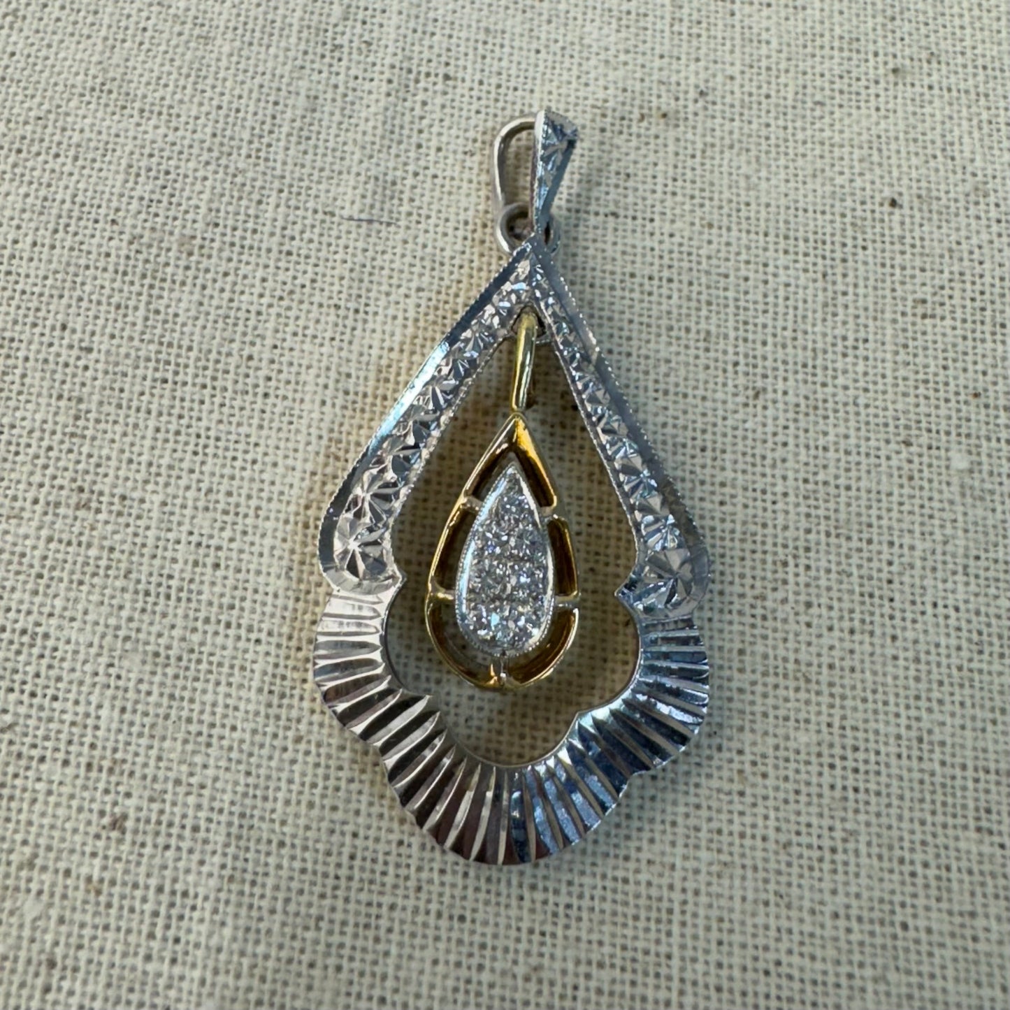 14K white and yellow gold pendant in a unique geometric design set with Diamonds