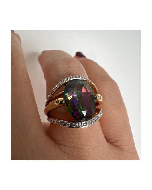 14K gold ring set with an oval Mystic Topaz