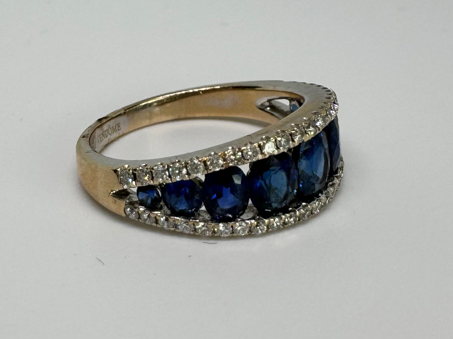 18K gold ring set with a row of deep blue Sapphire & Diamonds