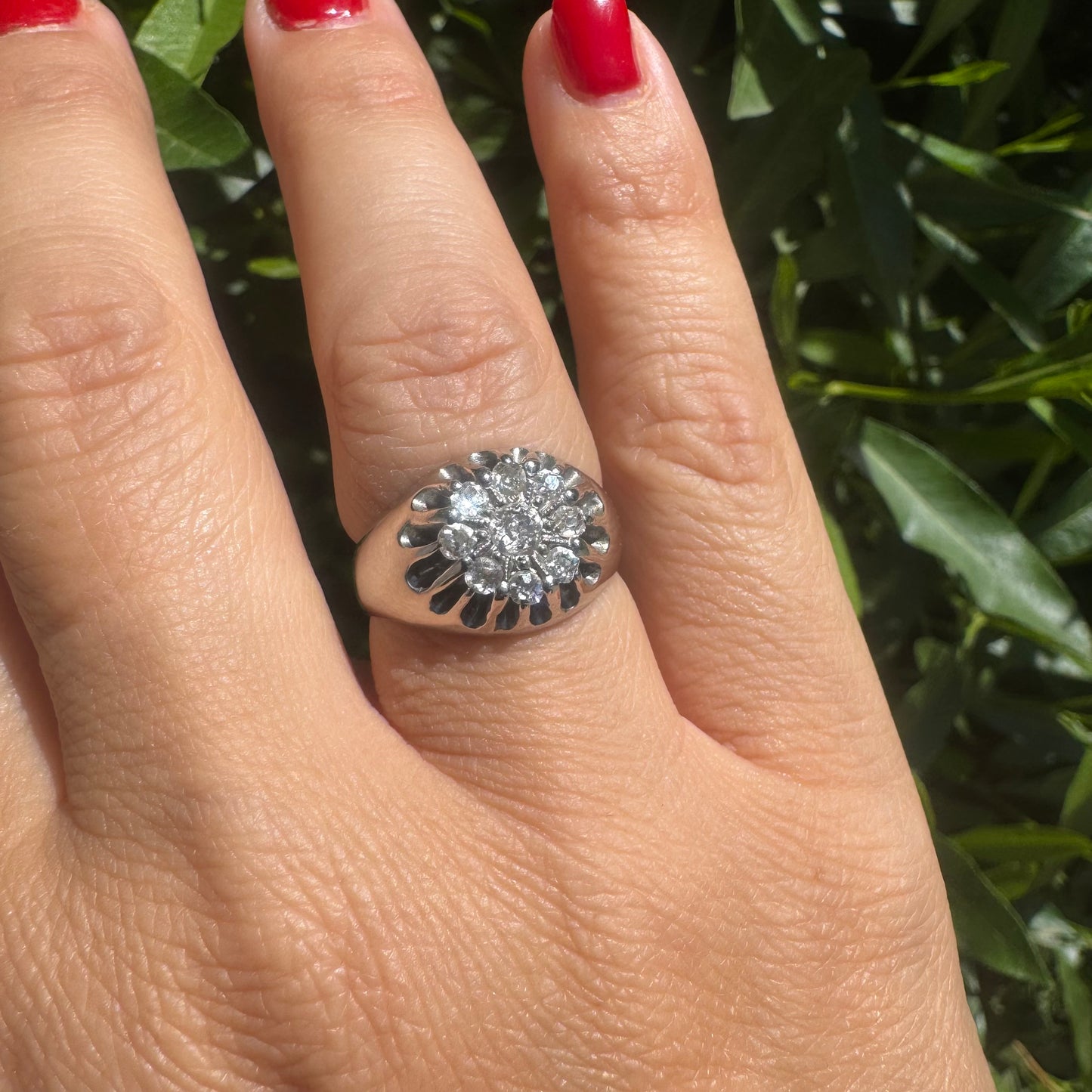 14K gold ring set with a cluster of old cut diamonds arranged in a floral design