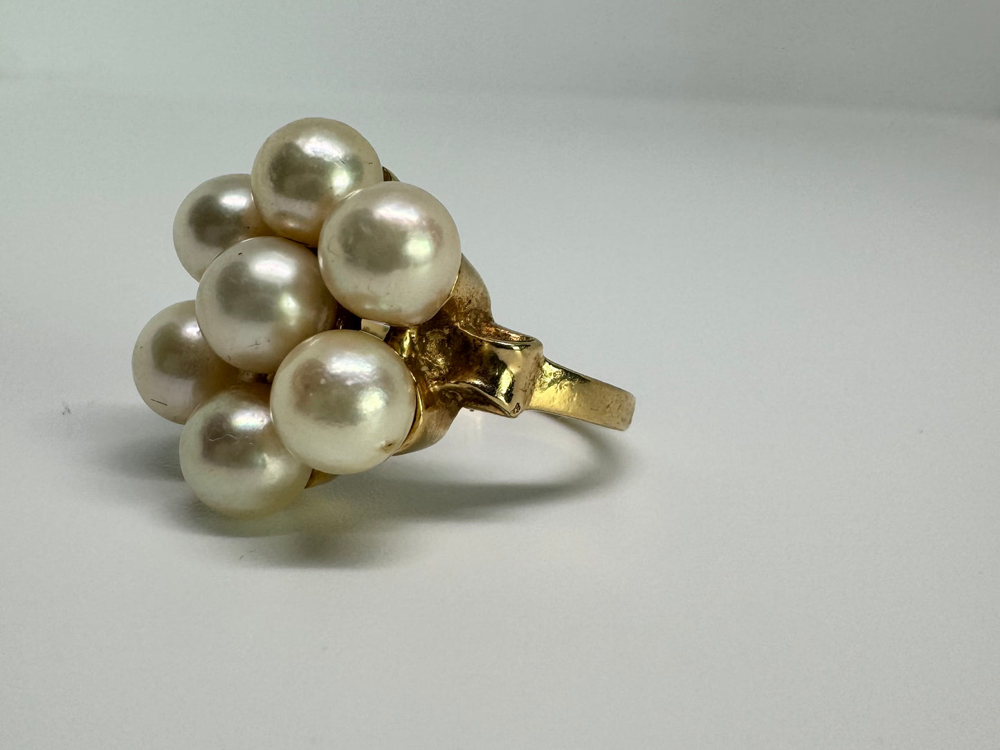 14K gold ring set with seven round Pearls in a bold floral cluster