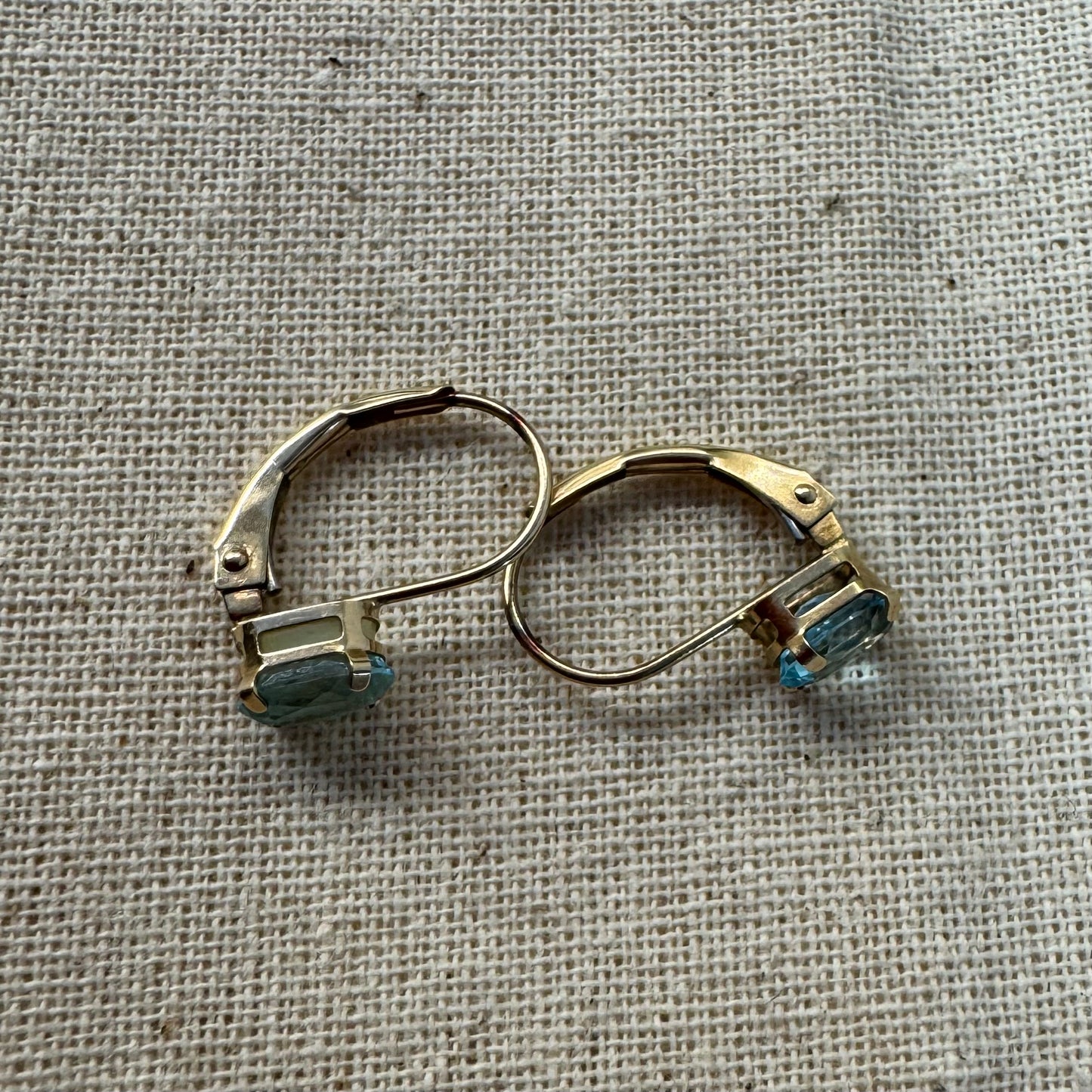 10K gold drop earrings set with sparkling blue topaz