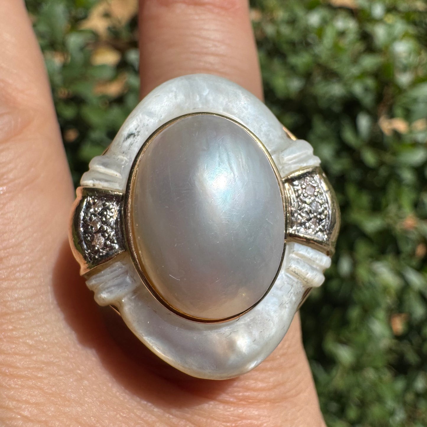 14K gold ring set with a natural mother-of-pearl centerpiece framed by delicate diamond accents