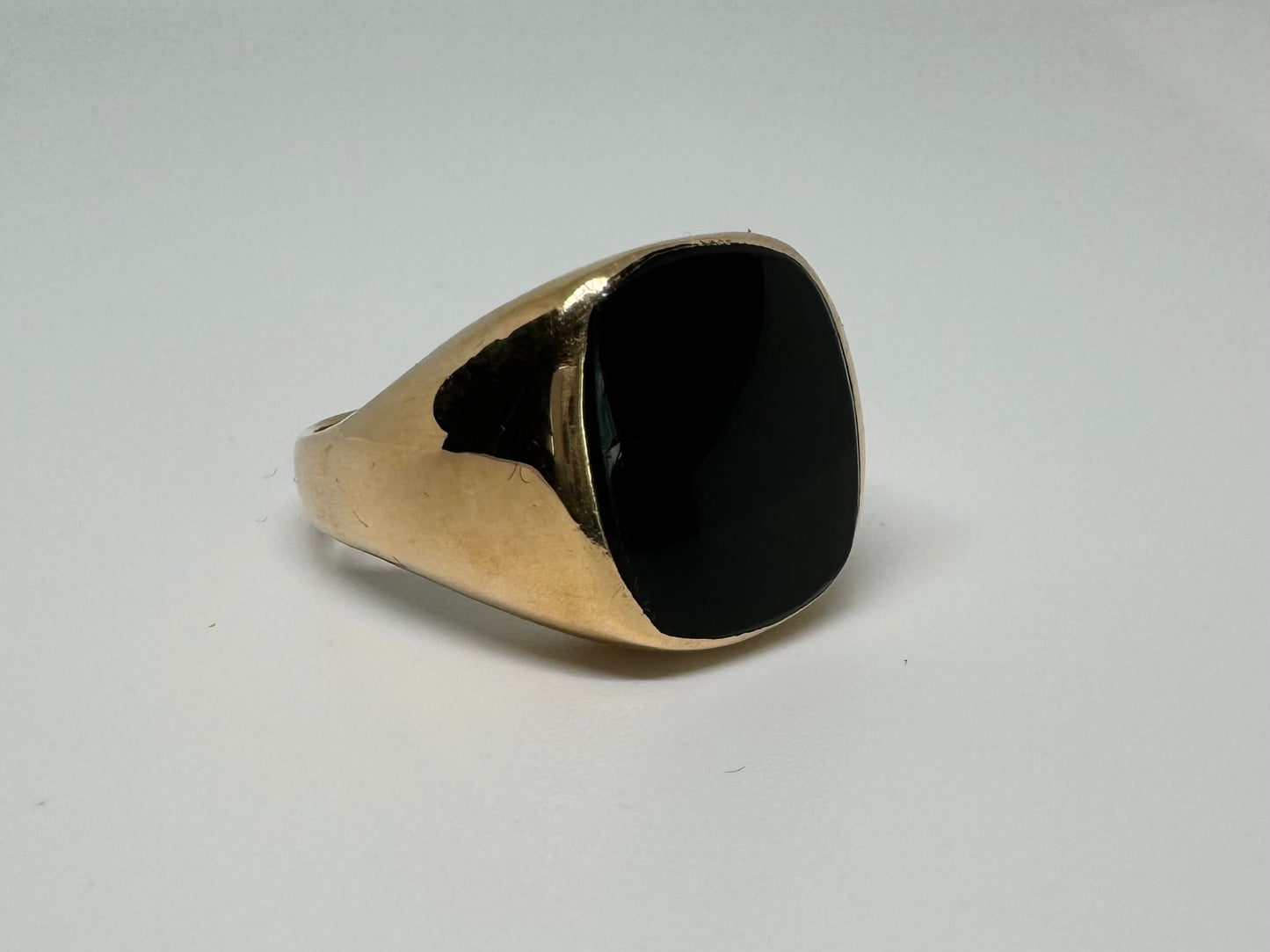 14K bold gold ring set with a smooth, square-shaped black Onyx that creates a sleek and striking look.
