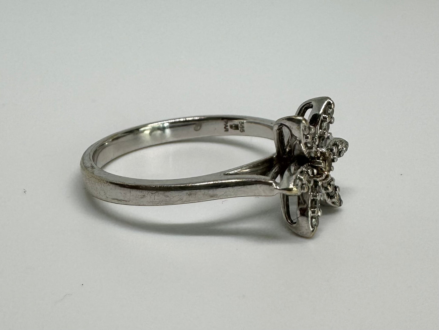 14K gold ring set with a floral design with six petal-shaped segments, each pavé-set with shimmering Diamonds