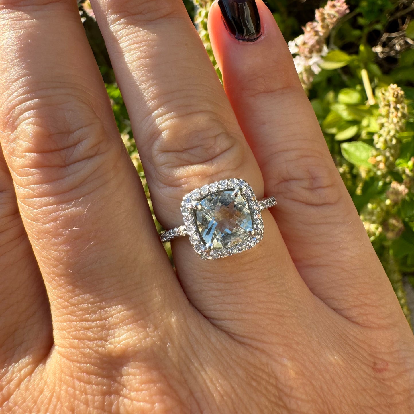 14K white gold ring featuring a cushion-cut light blue Aquamarine set in a sparkling double halo of round-cut Diamonds.