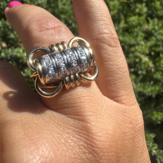 18K gold ring with a barrel-shaped centerpiece, crafted in yellow and white gold and set with sparkling Diamonds.