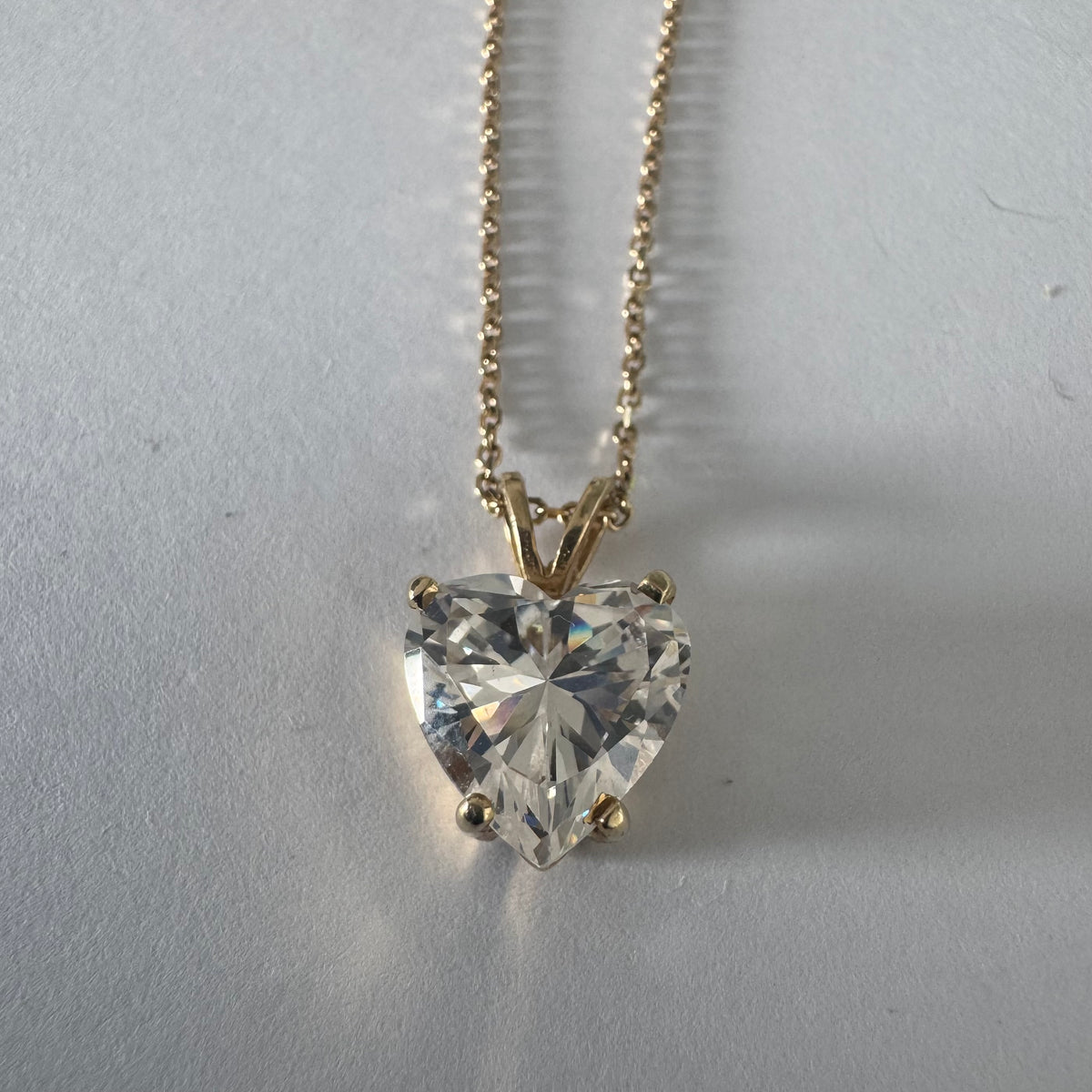 14K gold Heart Pendant set with a brilliant heart-cut clear stone.