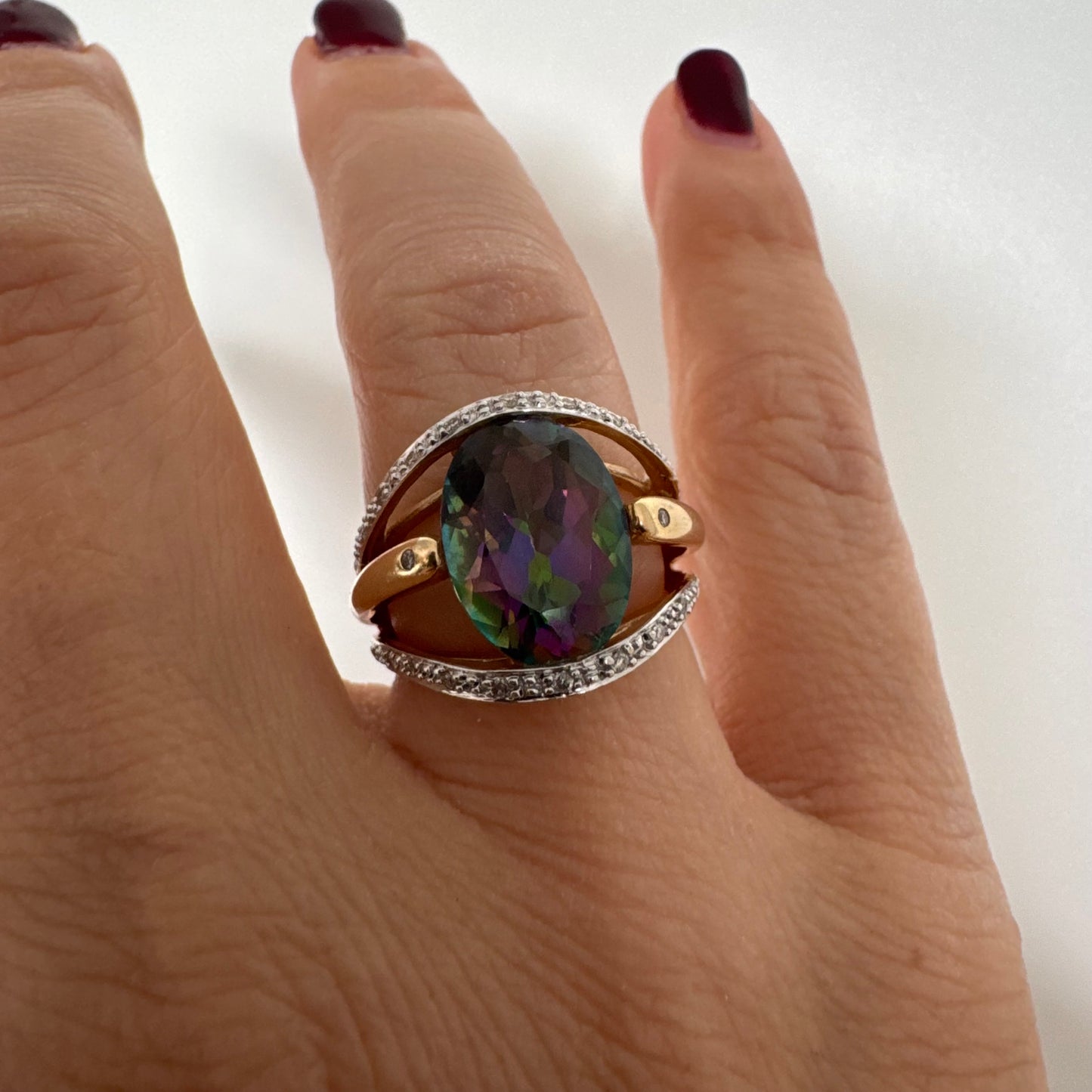 14K gold ring set with an oval Mystic Topaz