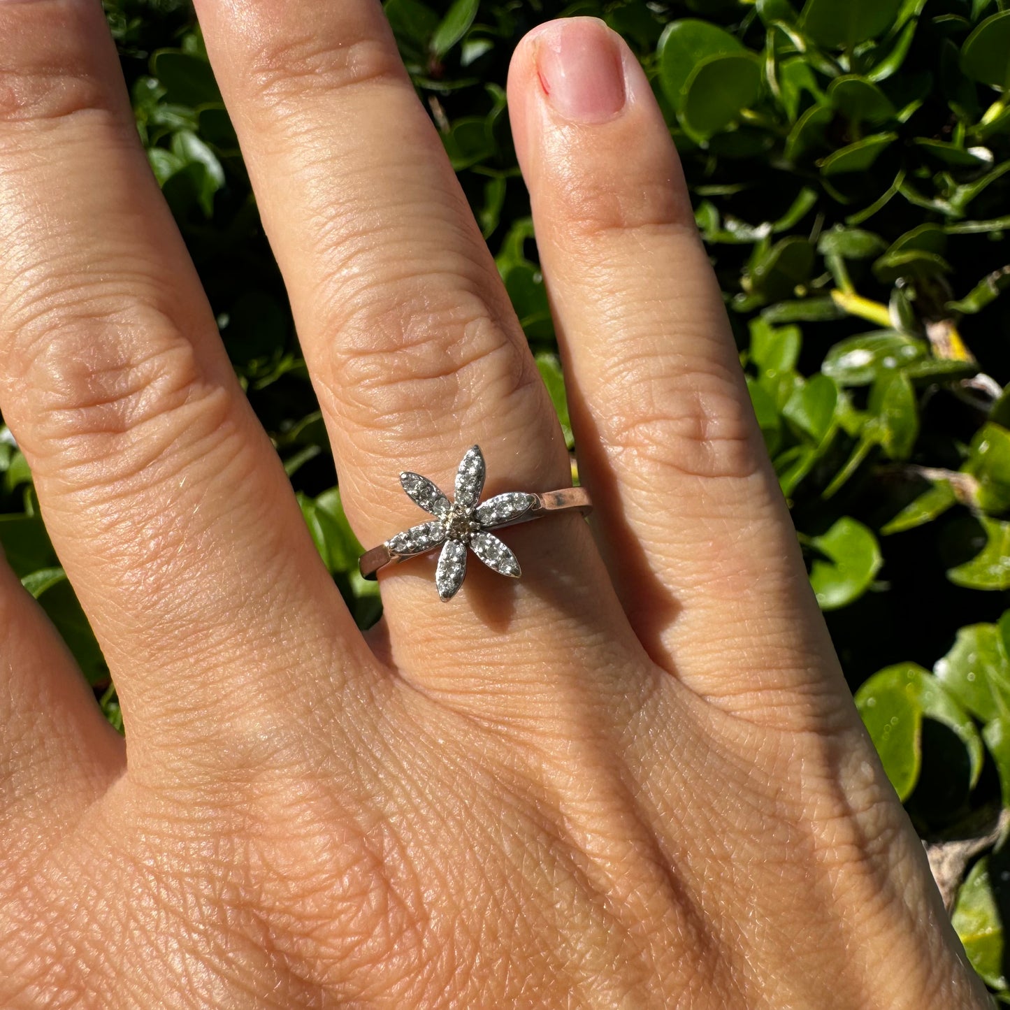 14K gold ring set with a floral design with six petal-shaped segments, each pavé-set with shimmering Diamonds
