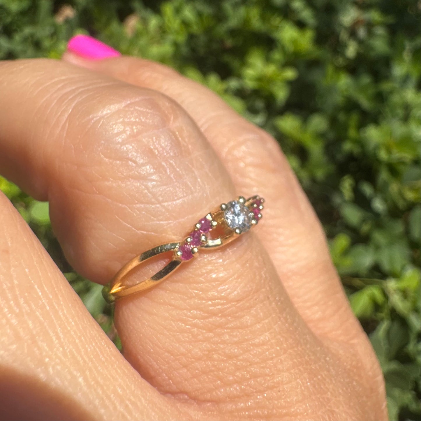 14K gold ring set with a central round Diamond, accented with Rubies along the band.