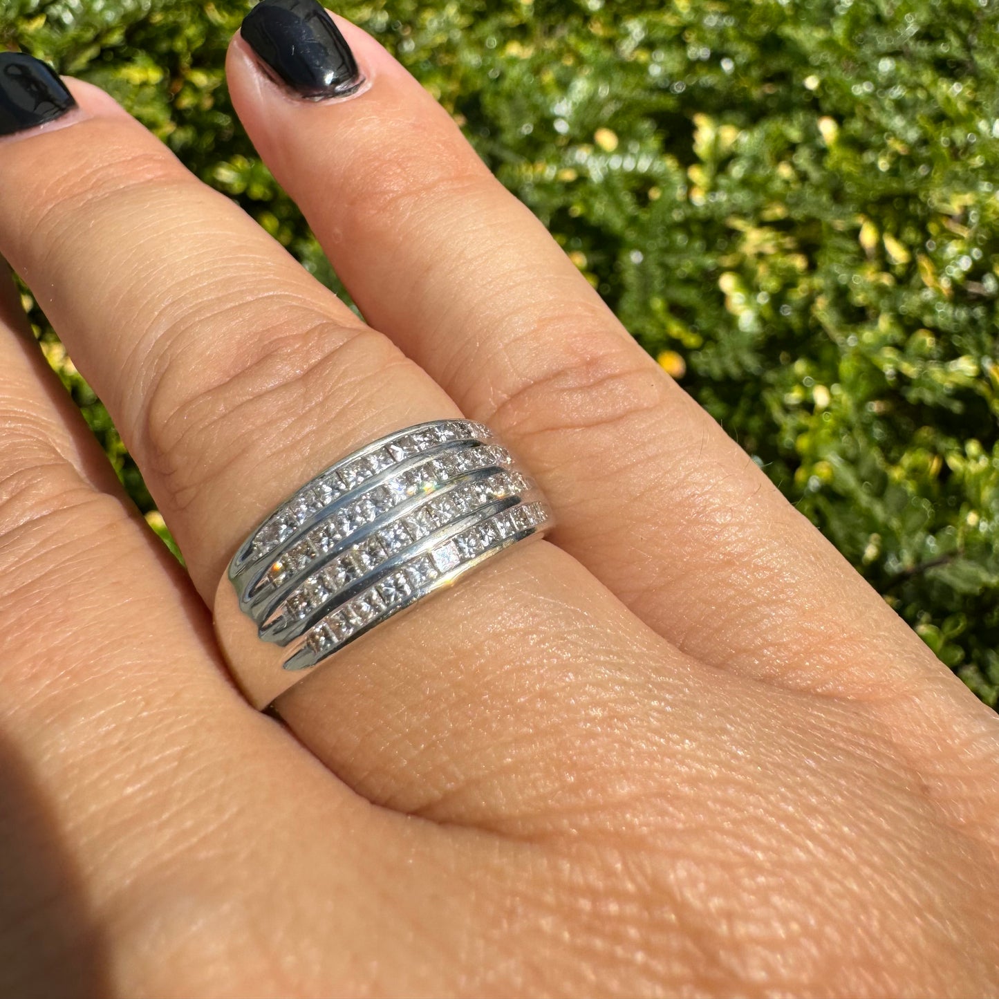 14K gold ring set with four parallel rows of princess-cut Diamonds.