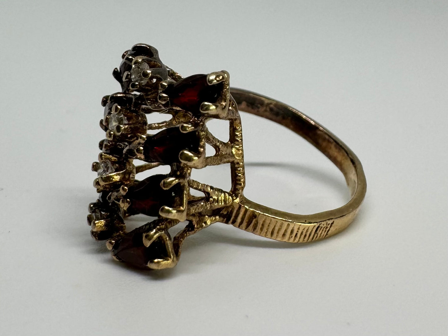 14K gold ring set with deep red teardrop Garnets and sparkling Diamonds in an openwork geometric design