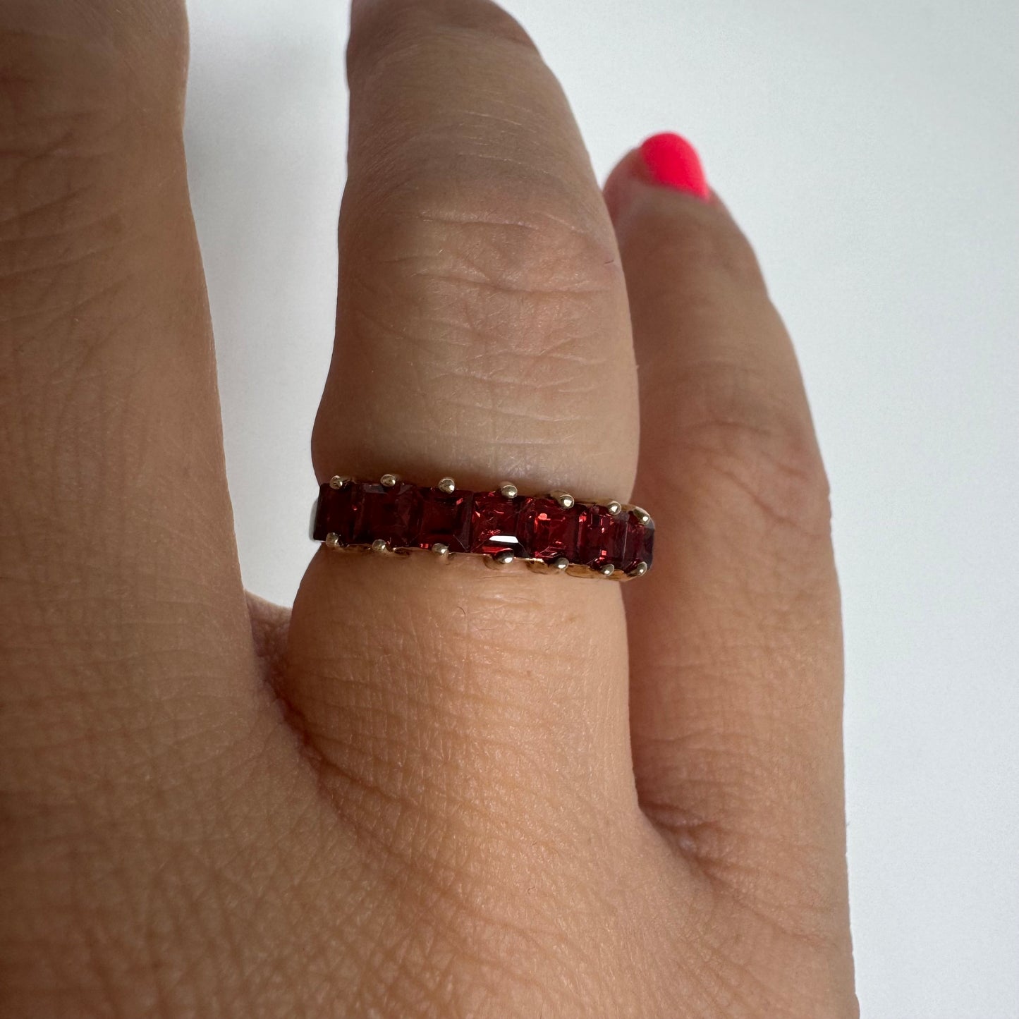 9K gold ring set with deep red garnets